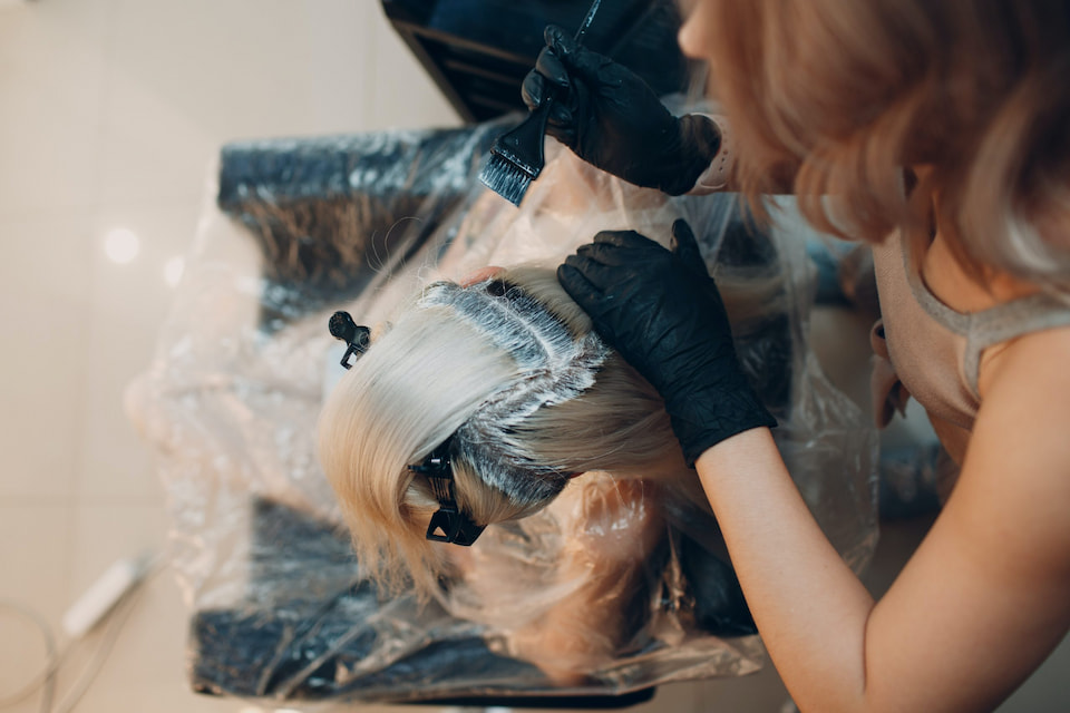 woman having her hair colored at a salon